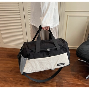 Large capacity black and white gym bag with reinforced handles and adjustable strap