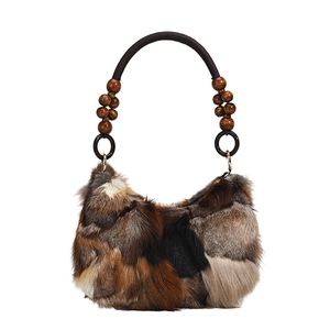 Vintage underarm bag featuring faux fox fur patchwork and decorative beaded handle