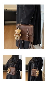 Détails du sac à dos vintage en daim marron avec pendentif ours et bretelles réglables