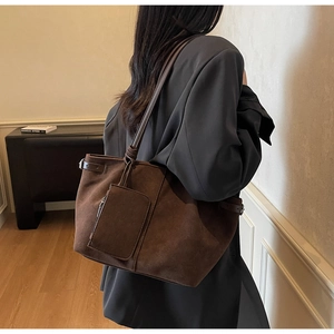 Detail of deep brown suede tote bag with matching coin pouch and slim straps