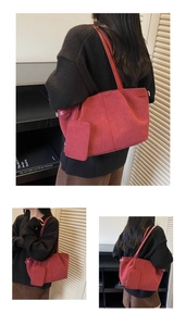 Detail view of red vintage tote bag with suede texture and matching mini pouch on shoulder