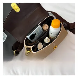Interior view of beige canvas crossbody bag showing spacious capacity and zipper pocket