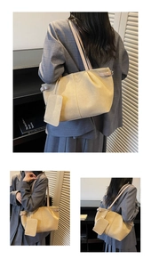 Detail of beige large tote bag with side metal buckle and matching small pouch charm