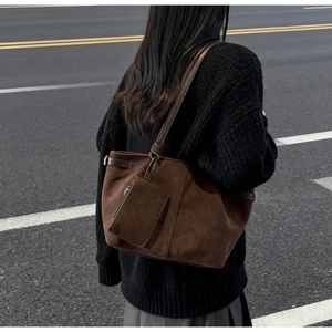 Macro view of vintage large capacity dark brown suede tote bag with small hanging pouch