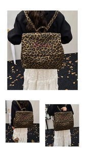 Detail view of large leopard print backpack with red embroidery and flap closure