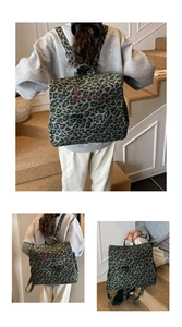 Detail view of leopard print backpack with red embroidery on the green flap cover