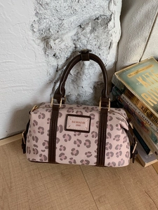 Pink leopard print Boston handbag with leather top handles and a vintage retro style