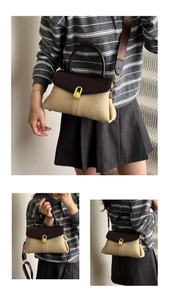 Detail of vintage beige canvas handbag with brown leather flap and golden twist lock