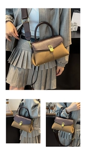 Detail of retro bicolor handbag with golden oval buckle and wide shoulder strap