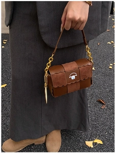 Detail of vintage brown contrast leather bag with gold chain and puppy logo print