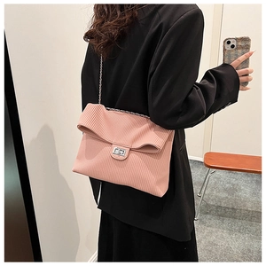 Detail of light pink pleated shoulder bag with silver chain strap and twist lock closure