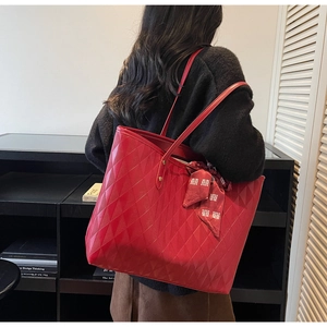 Detail of red quilted tote bag with festive silk scarf featuring traditional囍 pattern