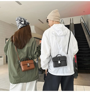 Detail of compact PU leather crossbody square bags in brown and black with metal buckle