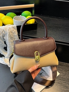 Chic two-tone brown and beige crossbody handbag with top handle and gold turn-lock closure