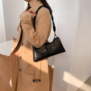 Chic black crocodile embossed underarm shoulder bag for women worn with wool coat