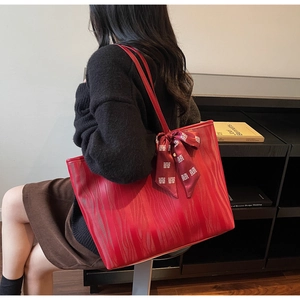 Detalle de bolso tote de cuero rojo con lazo de satén tradicional chino festivo