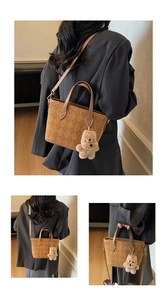 Brown faux suede bucket bag with check texture and cute plush bear charm detail