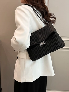 Chic black pleated chain shoulder bag with silver turn-lock and leather strap