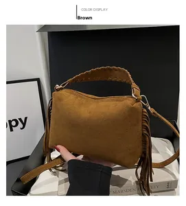 Detail of brown suede handbag featuring long fringes and delicate braided handles