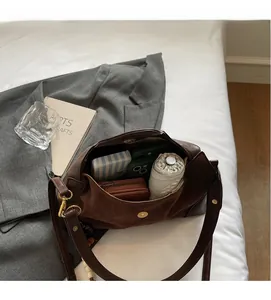 Detailed view of the spacious inner compartment of this brown suede tote bag