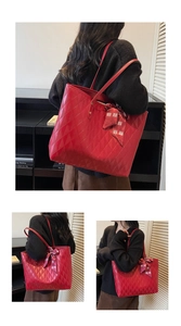 Detail view of large red quilted tote bag with decorative wedding knot silk scarf