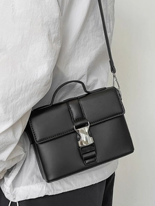 Classic black PU leather rectangular crossbody bag with silver buckle worn by a model
