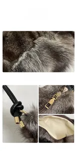 Detail of grey fox fur shoulder bag with woven leather strap and golden metallic hardware
