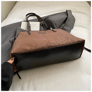 Detail view of large leopard print tote bag with brown velvet and black leather splicing