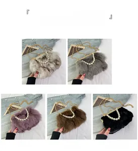 Detailed view of plush faux fox fur handbag with pearl handle and golden chain strap