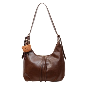 Retro brown hobo shoulder bag with glossy leather finish and cute plush bear charm