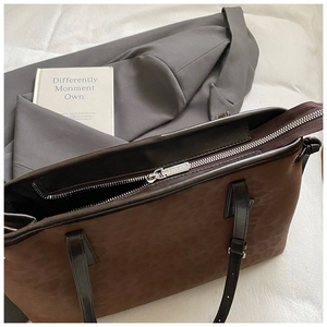 Detailed view of dark brown leopard print tote with premium silver zipper and leather strap