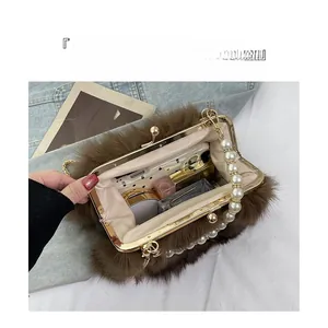Interior view showing the large capacity of the faux fox fur bag for makeup and phone