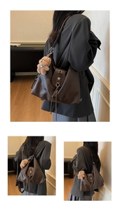 Detail of coffee brown leather tote bag with metal flower clasp and cute bear charm