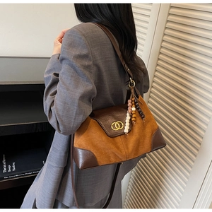 Detail of vintage leopard print tote bag with brown leather flap and gold hardware trim