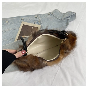 Detailed view of plush faux fur shoulder bag with soft inner lining and golden hardware
