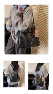 Close-up of black leather tote bag with floral metal buckle, fringe and bear charm