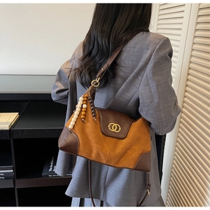 Detail of camel suede and brown leather shoulder bag with metallic double ring buckle