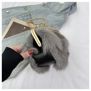 Detail of grey fox fur mini crossbody bag with gold chain strap and metal clasp