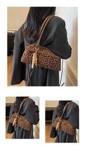 Close-up of vintage leopard print tote with brown leather straps and beaded tassel