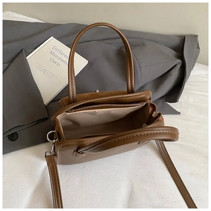 Detail view of the coffee brown PU leather bowling bag showing inner lining and stitching