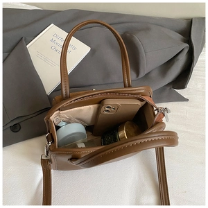 Interior view of brown leather bowling bag showing large storage capacity and zipper
