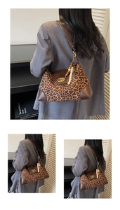 Detail of leopard print tote bag featuring vintage leather trim and metallic ring clasp