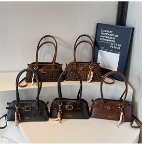 Various leather shoulder bags in black, brown, and leopard print with metal buckle detail