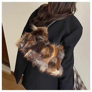 Detail of plush faux fur patchwork shoulder bag in brown tones with slim black strap