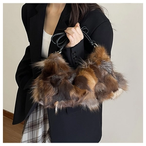Detail of multi-color plush patchwork shoulder bag with sleek black strap and fuzzy texture