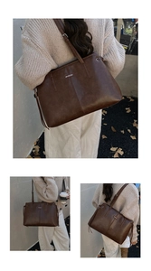 Detail of deep brown vintage tote bag featuring metal logo plate and side drawstring