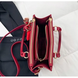 Internal view of red bridal handbag with multiple compartments and printed silk scarf