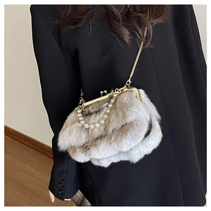 Detail of taupe faux fur crossbody bag with white pearl handle and gold chain strap
