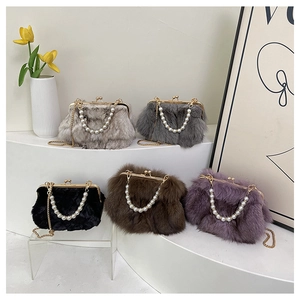 Detailed view of fluffy faux fur evening bags in multiple colors with pearl handles