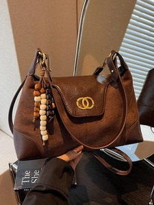 Large dark brown leopard print tote bag with metallic clasp and vintage beaded charm